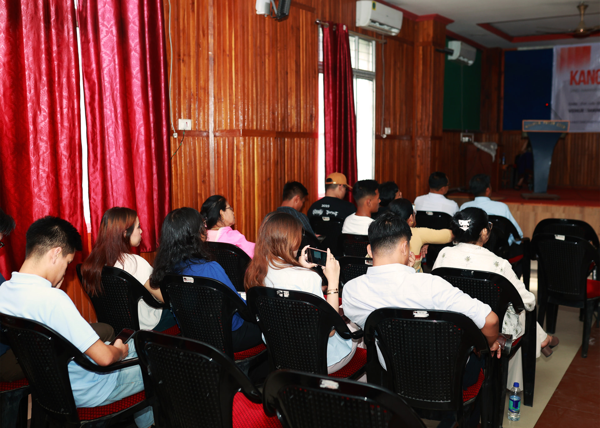 Audience facing the Kanglei Sannathong Pvt. Ltd. stage during a skills and compliance workshop.
