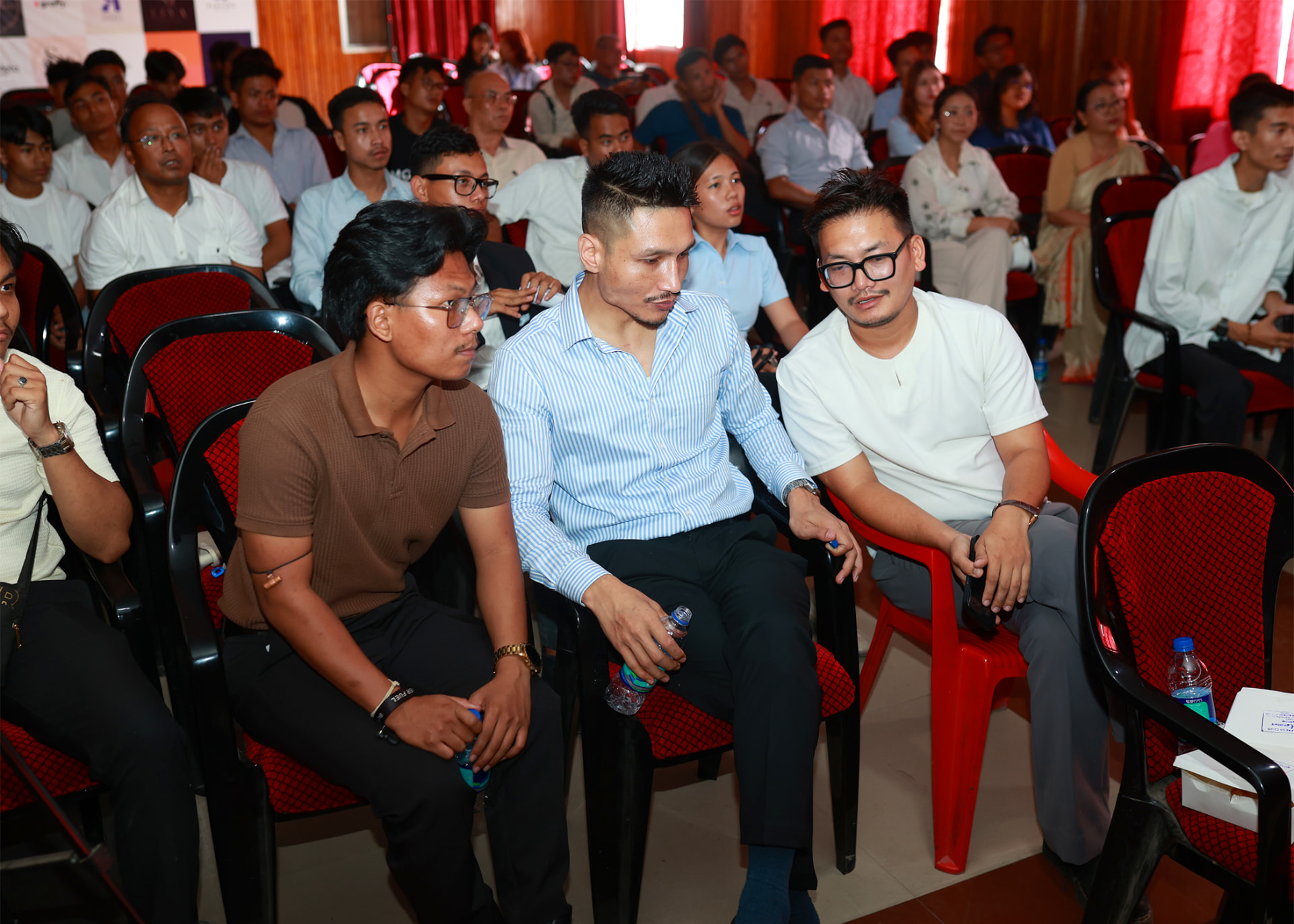 Participants at a Kanglei Sannathong community event in Imphal, seated in an auditorium.